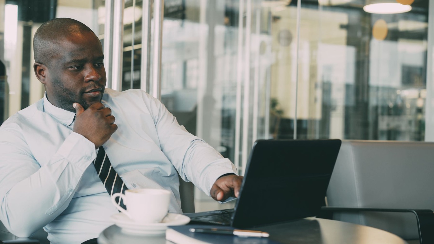 Un professionnel suit une formation en ligne sur son ordinateur portable.